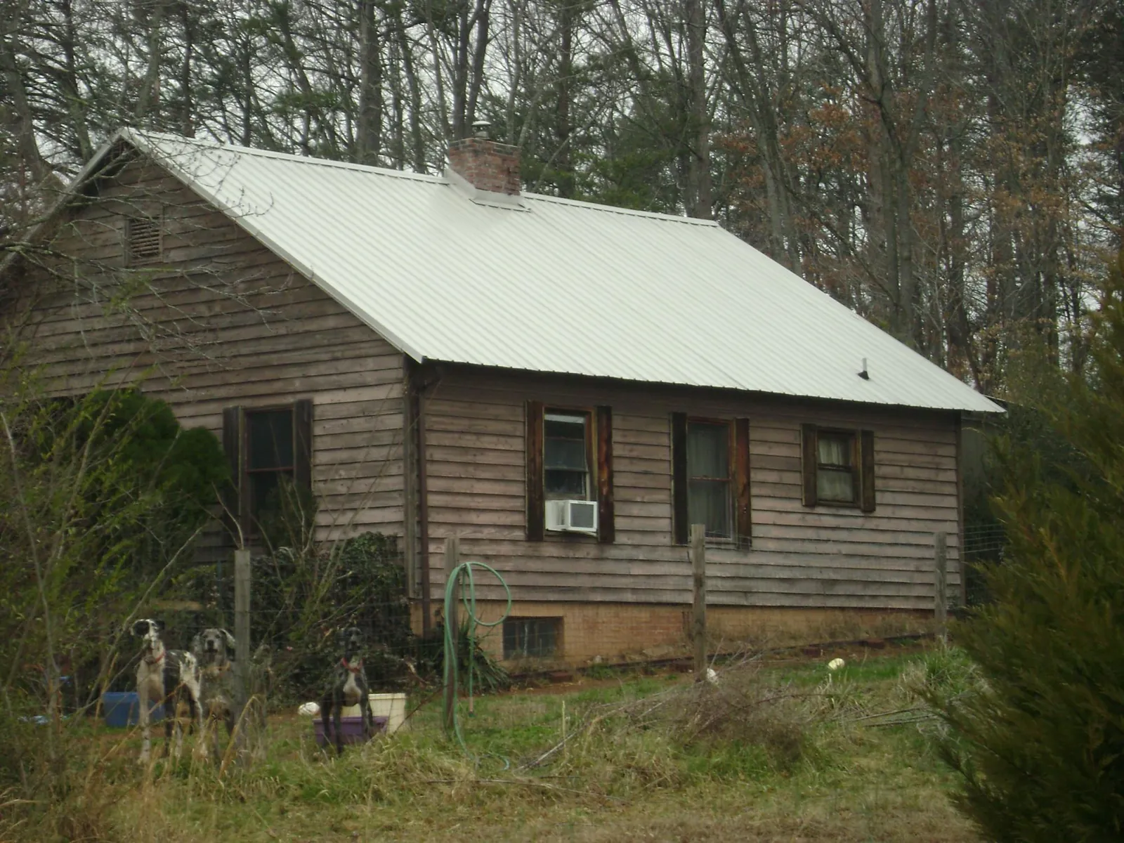 White metal roof on an old wood sided farmhouse, from a Asphalt Shingle Roof Repair job in New Cumberland
